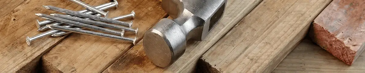Hammer and nails on hardwood flooring boards in Santa Ana, CA