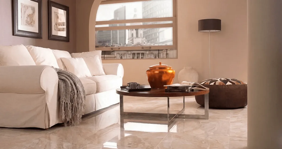 Modern living room with professionally installed marble flooring, a beige sofa, coffee table in Santa Ana, CA